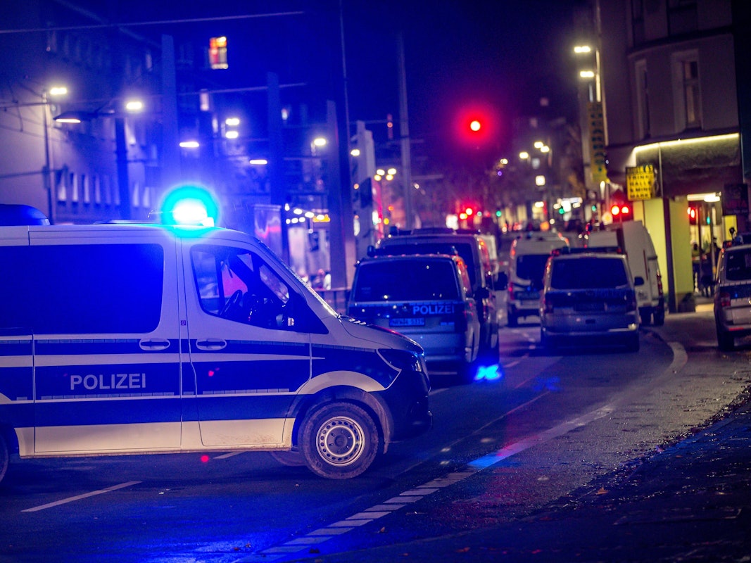 Das Symbolfoto, aufgenommen am 21. November 2021 in Dortmund, stellt ein Polizeiauto mit blinkendem Blaulicht auf einer Hauptstraße bei Nacht dar.