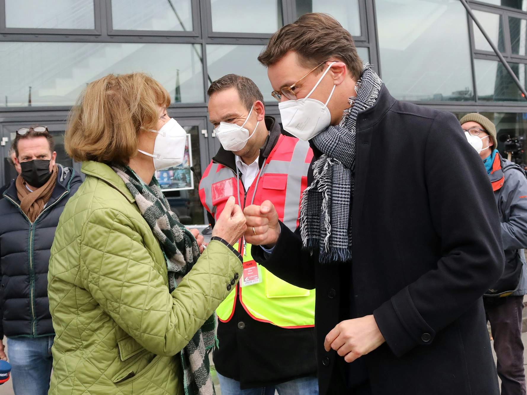 Oberbürgermeisterin Henriette Reker und Ministerpräsident Hendrik Wüst begrüßen sich vor dem Eingang der Lanxess Arena.