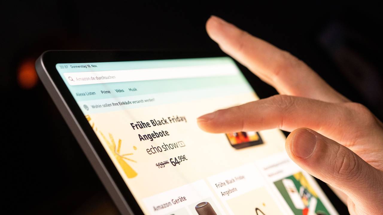 Eine Person schaut sich die Black Friday Angebote auf der Online-Shopping-Seite von Amazon auf seinem Tablet-Computer an.