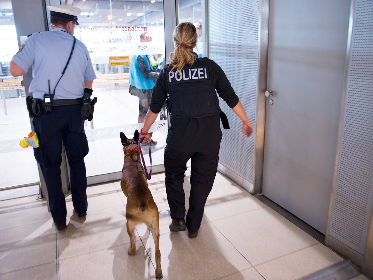 Polizisten mit einem Hund betreten 30.05.2016 den Sicherheitsbereich im Terminal 1 am Flughafen Köln/Bonn (Nordrhein-Westfalen).