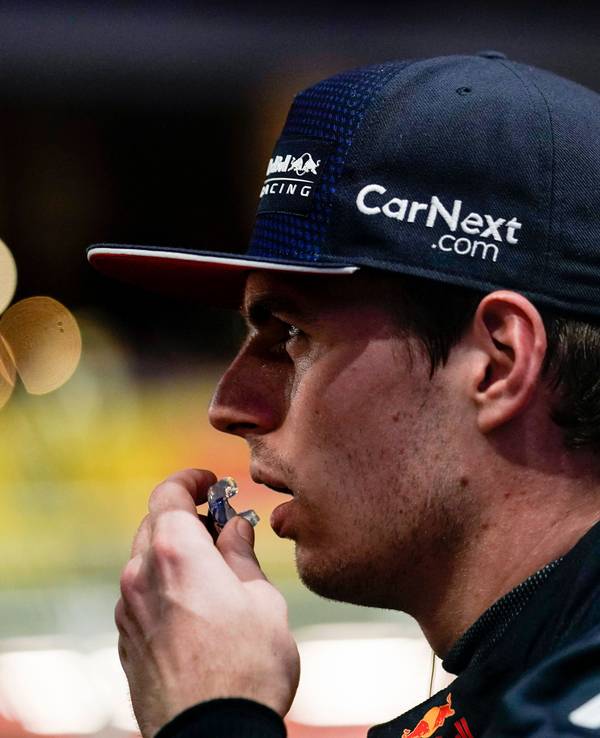 Max Verstappen trägt eine Kappe und schaut mit geöffnetem Mund zur Seite.