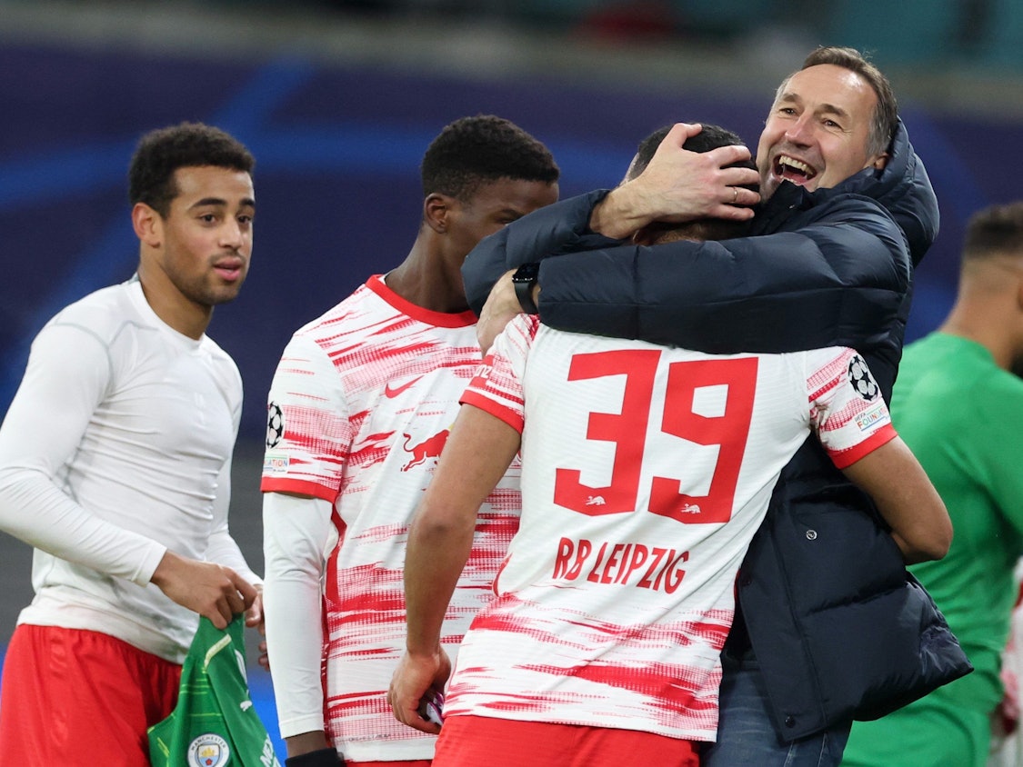 Leipzigs Interimstrainer Achim Beierlorzer (r) umarmt nach dem Sieg Benjamin Henrichs.