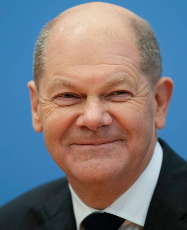 Bundeskanzler Olaf Scholz lächelt am 7. Dezember 2021 in die Kameras. Zuvor wurde der Koalitionsvertrag in Berlin besiegelt.