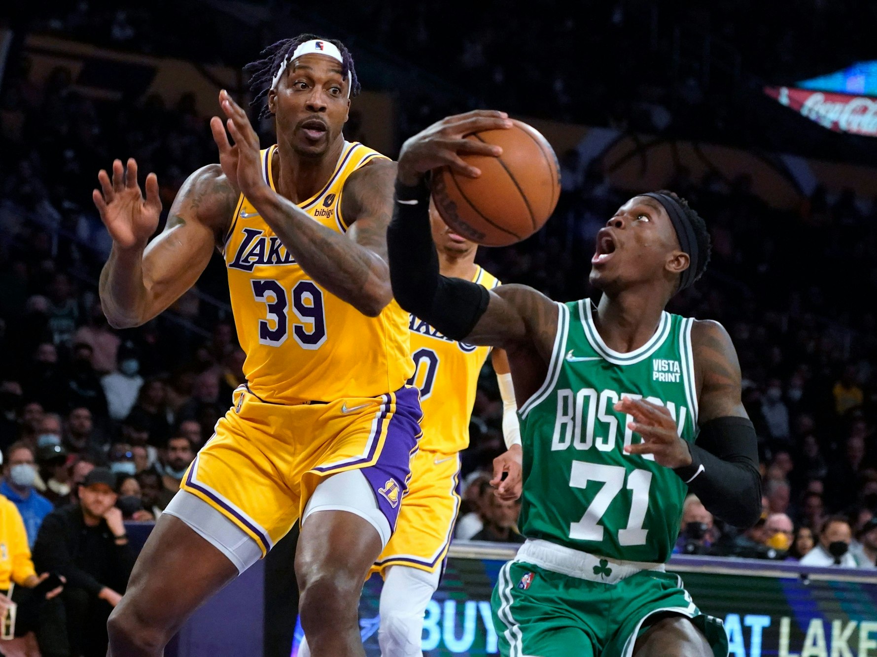 Dennis Schröder hat den Ball in der Hand, reißt den Mund auf. Dwight Howard versucht zu verteidigen.