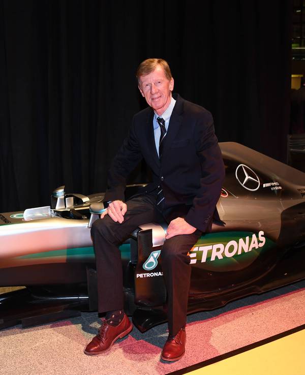 Walter Röhrl sitzt auf eine Formel-1-Auto von Mercedes.