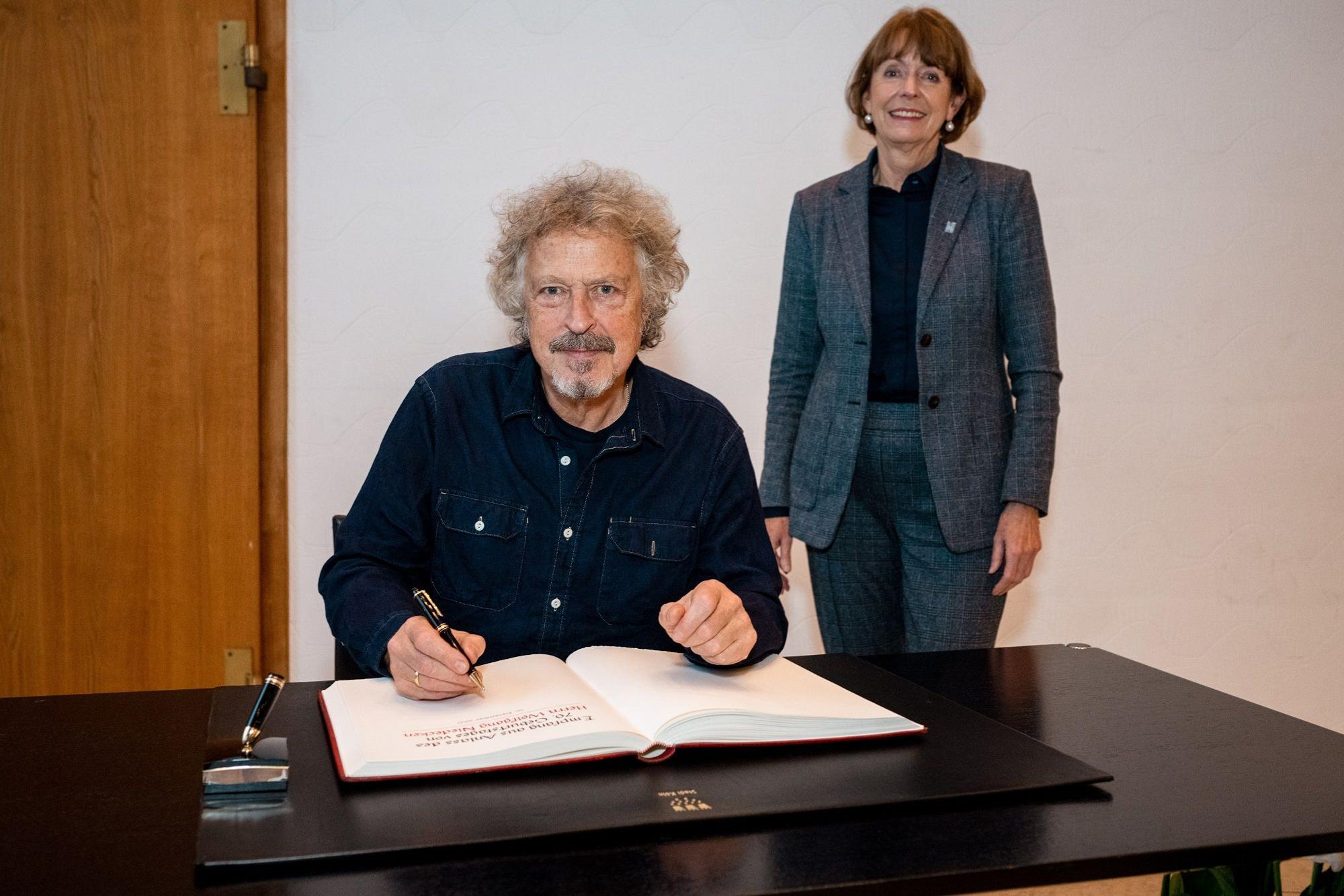 Wolfgang Niedecken trägt sich ins Gästebuch der Stadt Köln ein.