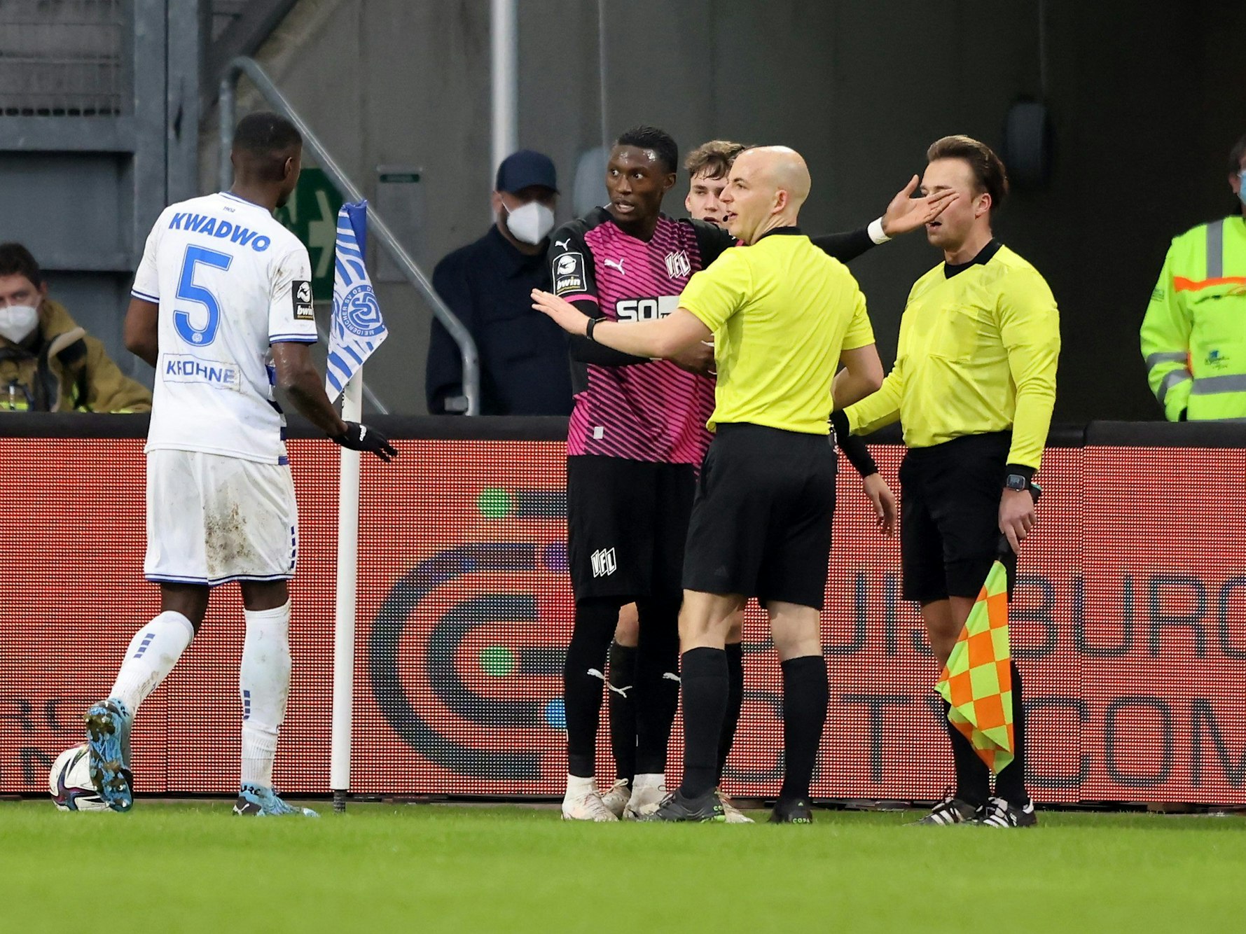 Aaron Opoku spricht mit Schiedsrichter Nicolas Winter und Leroy Kwadwo nachdem er von einem Zuschauer rassistisch beleidigt wurde.