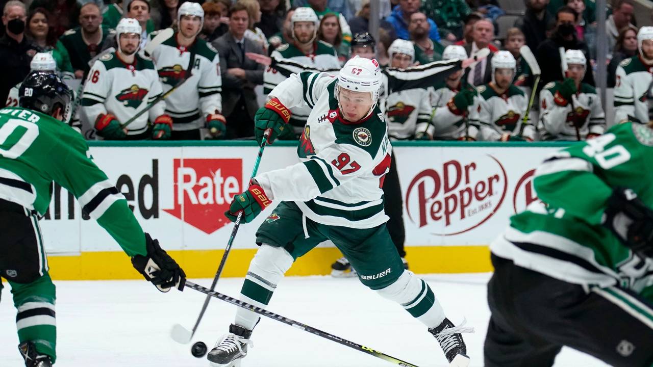 Dallas Stars defenseman Ryan Suter (20) defends against a shot by Minnesota Wild left wing Kirill Kaprizov (97) in the second period of an NHL hockey game in Dallas, Monday, Dec. 20, 2021. (AP Photo/Tony Gutierrez)
