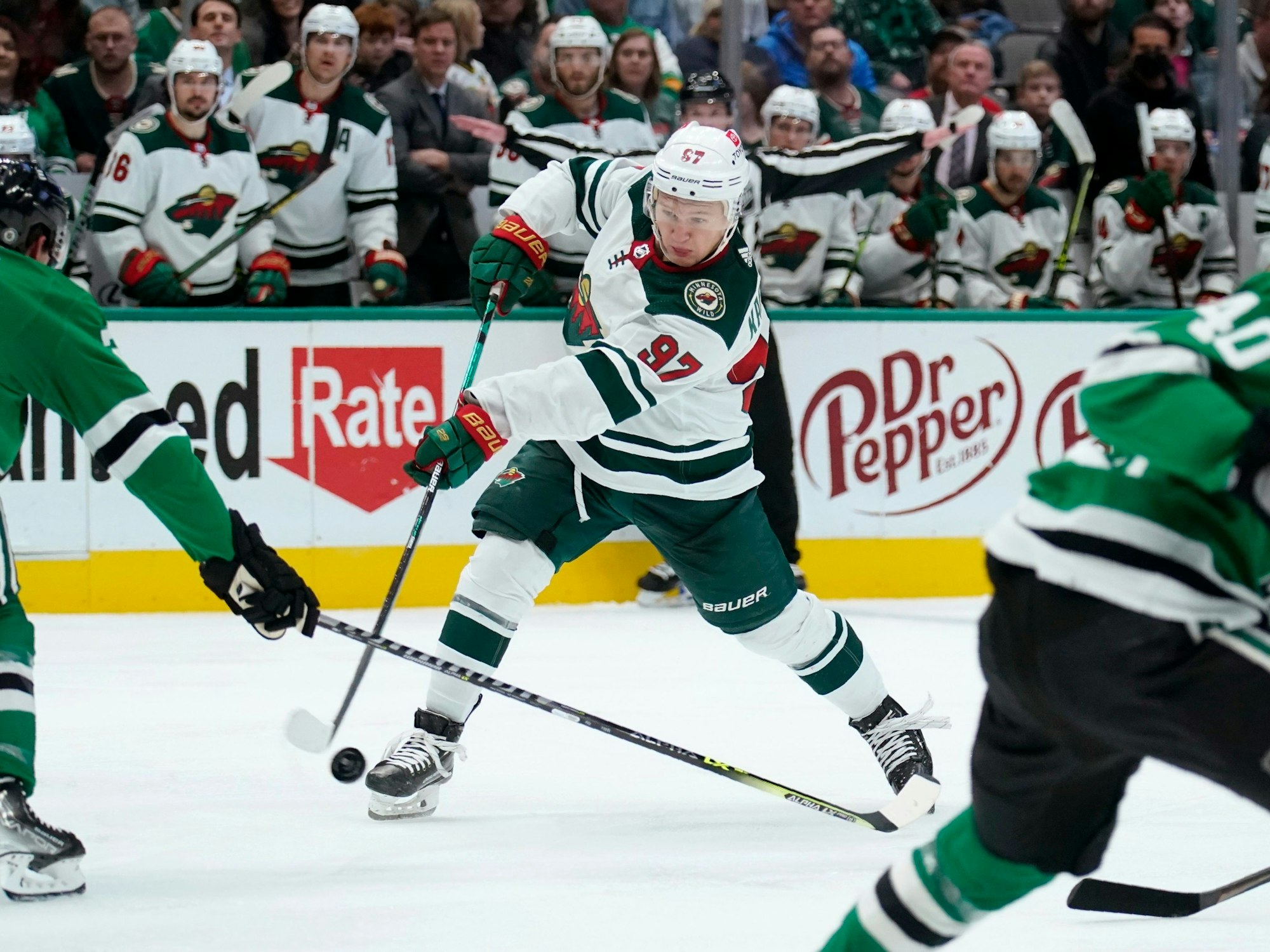 Dallas Stars defenseman Ryan Suter (20) defends against a shot by Minnesota Wild left wing Kirill Kaprizov (97) in the second period of an NHL hockey game in Dallas, Monday, Dec. 20, 2021. (AP Photo/Tony Gutierrez)