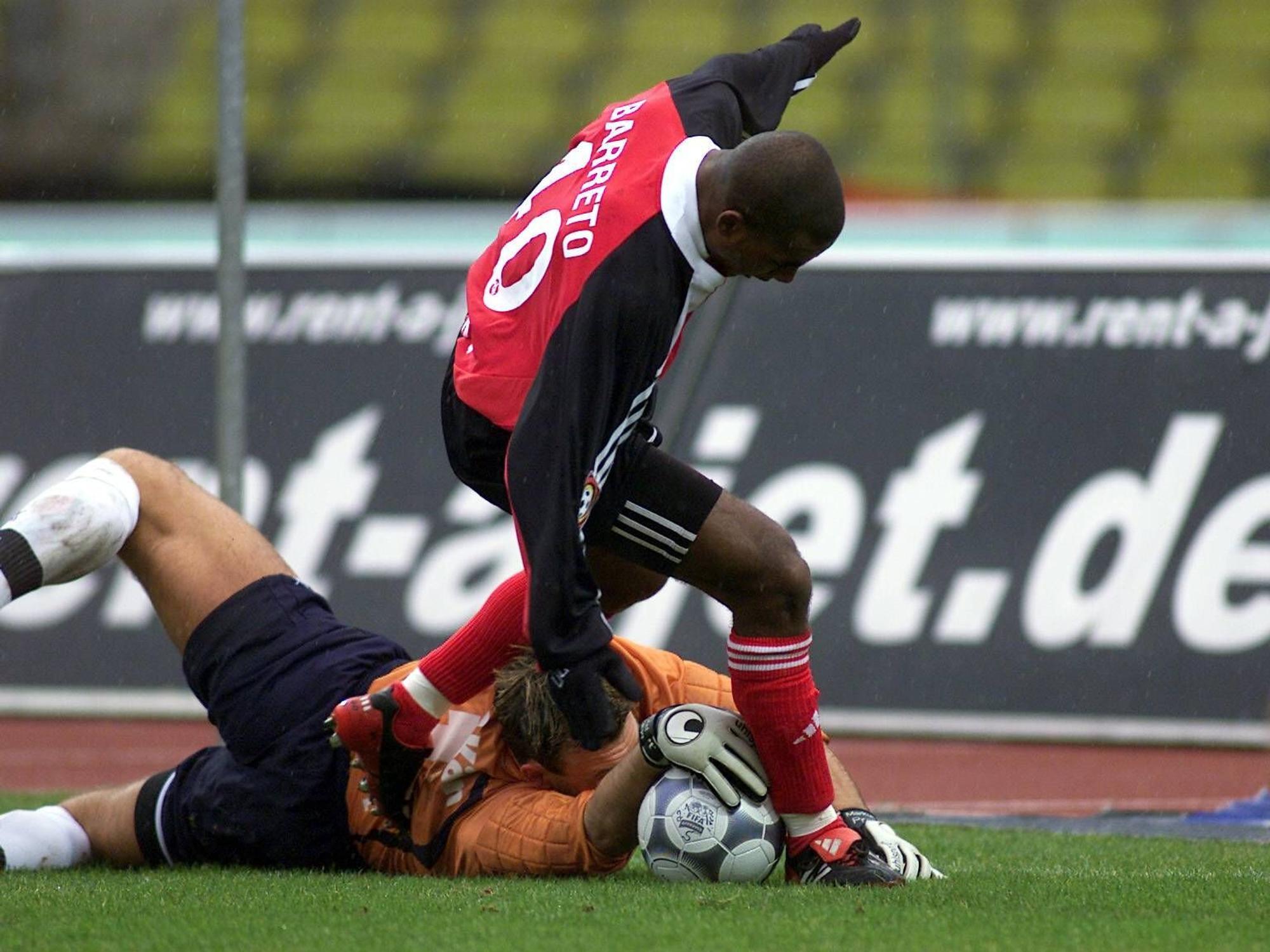 Markus Pröll liegt zwischen den Beinen von Nürnbergs Cacau und hat die Hand auf dem Ball.