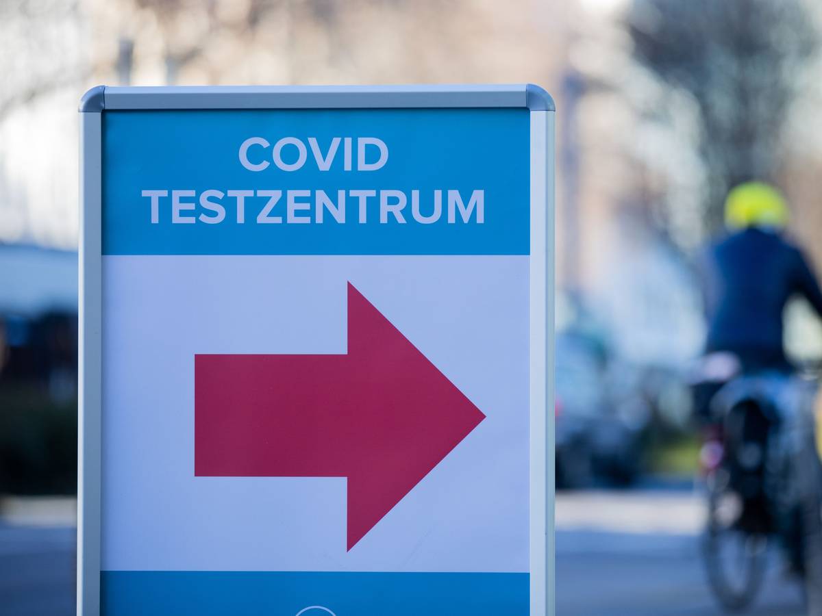 Ein Schild weist im Kölner Stadtzentrum den Weg zu einem Corona-Testzentrum.