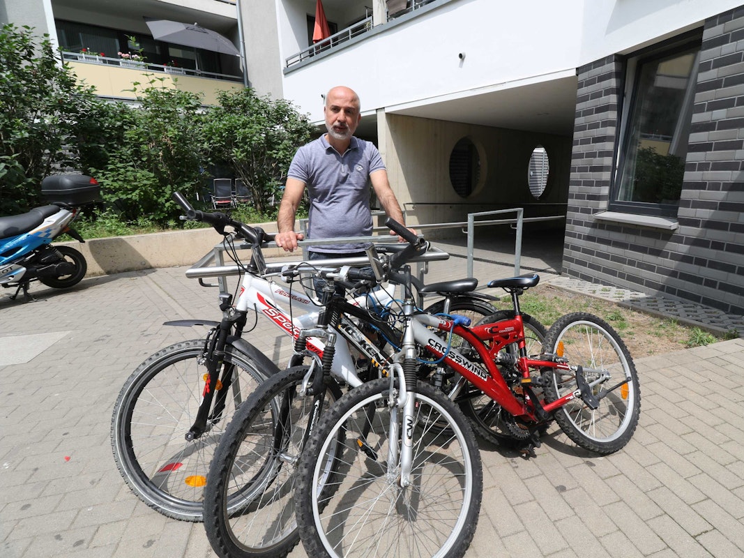 Yilmaz Özkul steht neben den Fahrrädern, die er beim Fundbüro der Stadt Köln gekauft hatte.