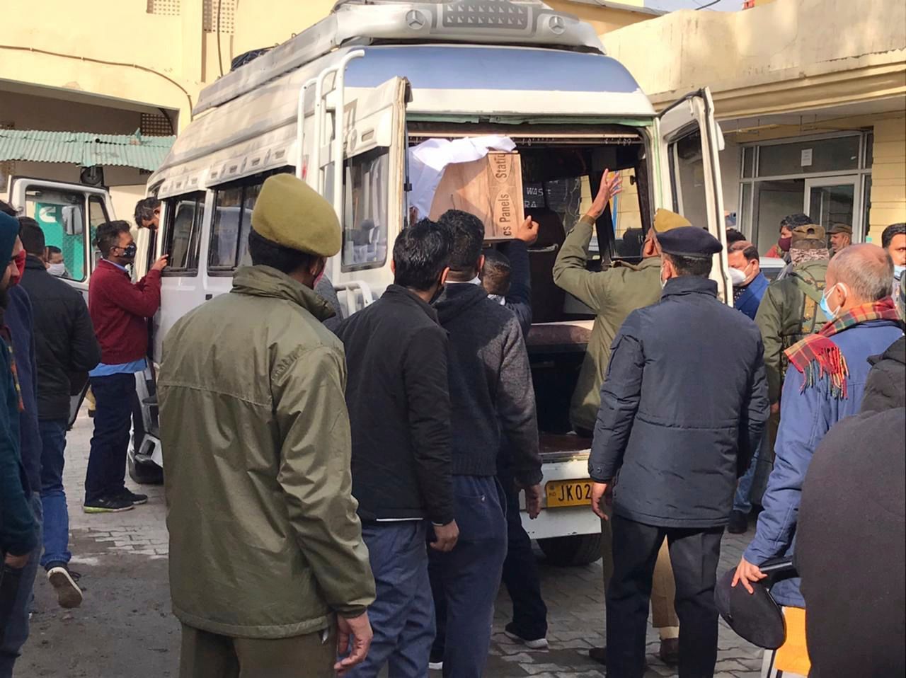 Polizisten helfen beim Verladen des Sarges eines Opfers einer Massenpanik in einem Gesundheitszentrum in Indien.