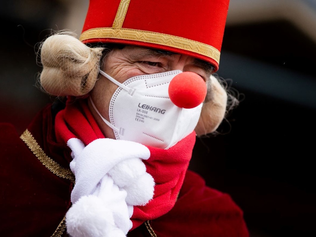 Köln: Ein Jeck mit Maske und Verkleidung steht am Severinstor, wo normalerweise der Rosenmontagszug startet.