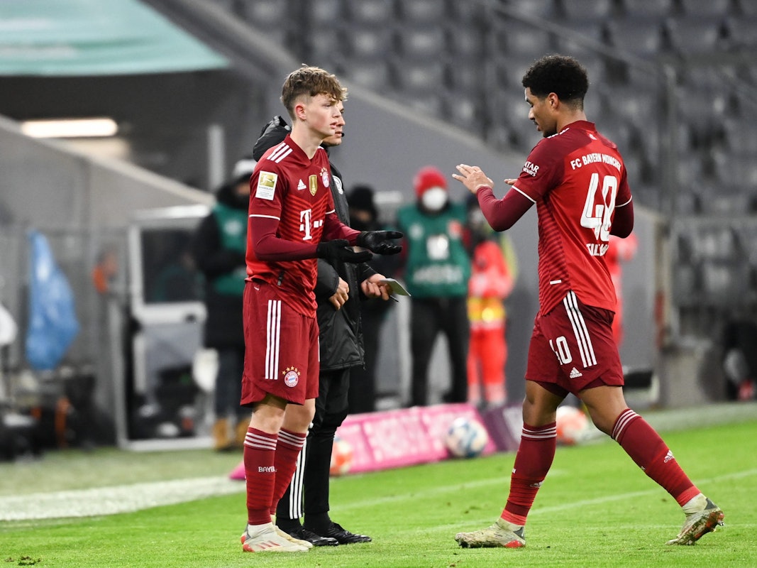 Paul Wanner klatscht im Spiel des FC Bayern mit Malik Tillman ab.