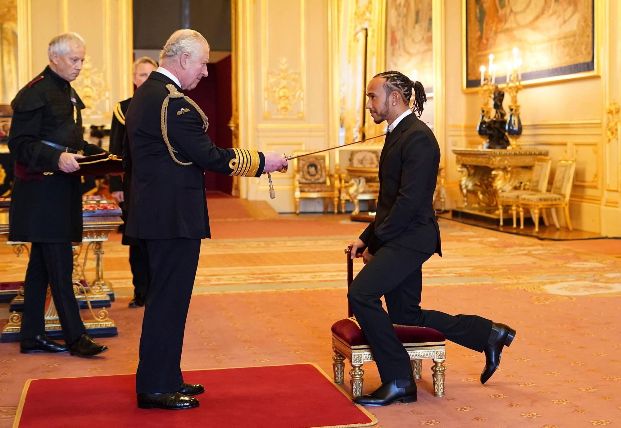 Lewis Hamilton is made a Knight Bachelor by Britain's Prince Charles at Windsor Castle, in Windsor, England, Wednesday, Dec. 15, 2021. (Dominic Lipinski/PA via AP)
