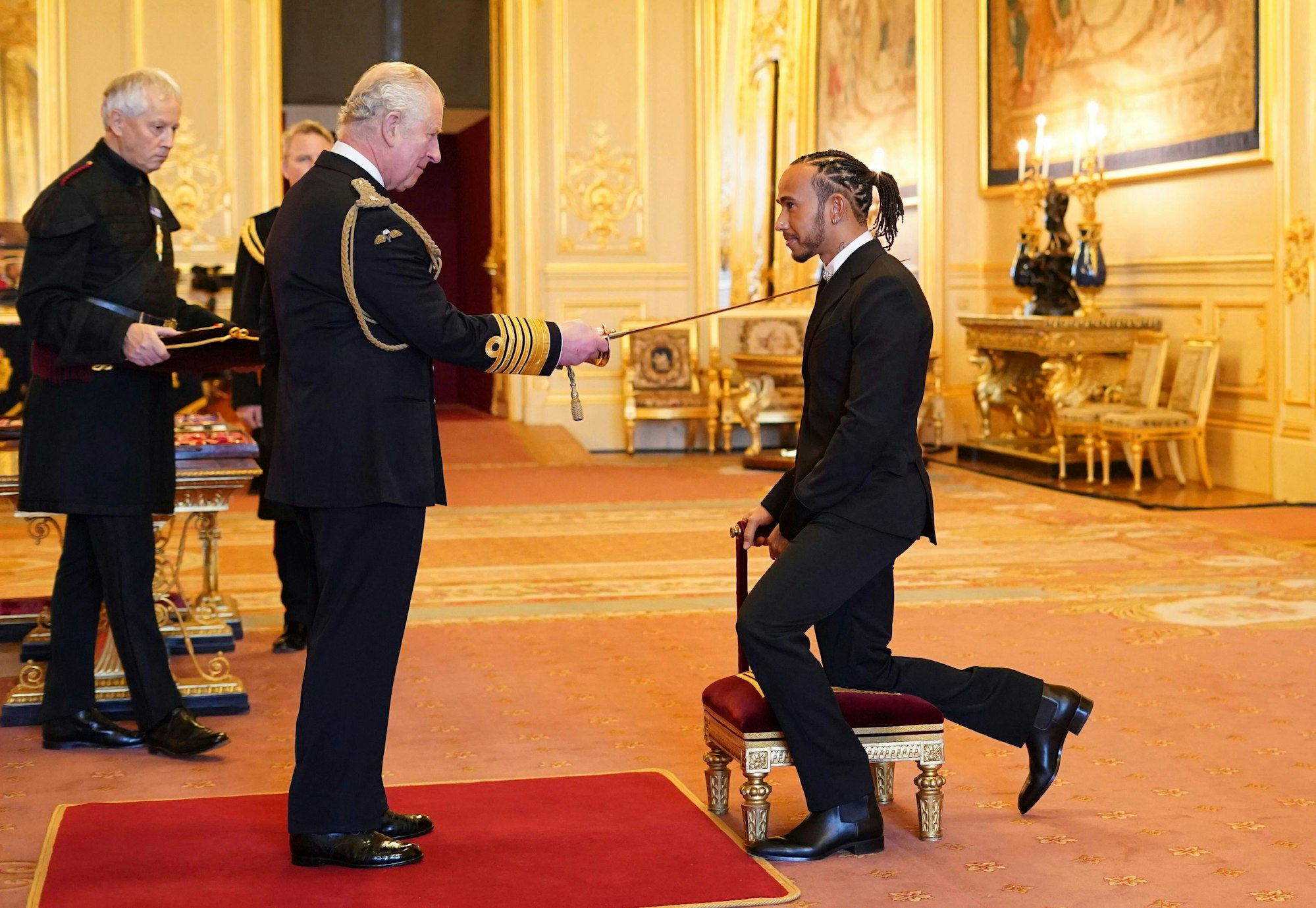 Lewis Hamilton is made a Knight Bachelor by Britain's Prince Charles at Windsor Castle, in Windsor, England, Wednesday, Dec. 15, 2021. (Dominic Lipinski/PA via AP)