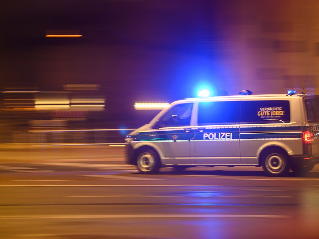Ein Polizeiwagen mit Blaulicht fährt am Silvesterabend durch die Dresdener Innenstadt zu einem Einsatz.