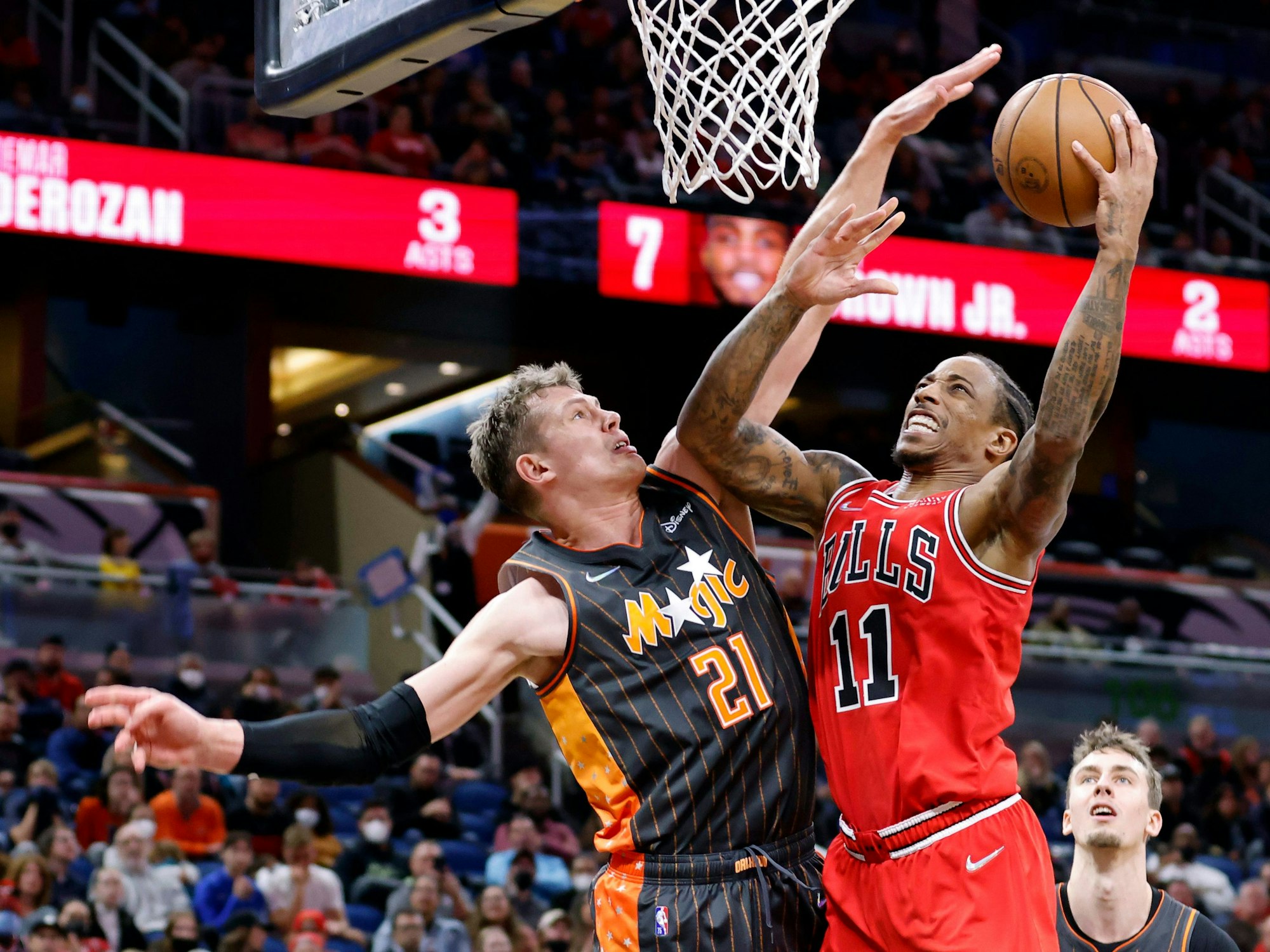 DeMar DeRozan springt zum Korbleger hoch, Moritz Wagner schlägt mit seiner Hand nach dem Ball.