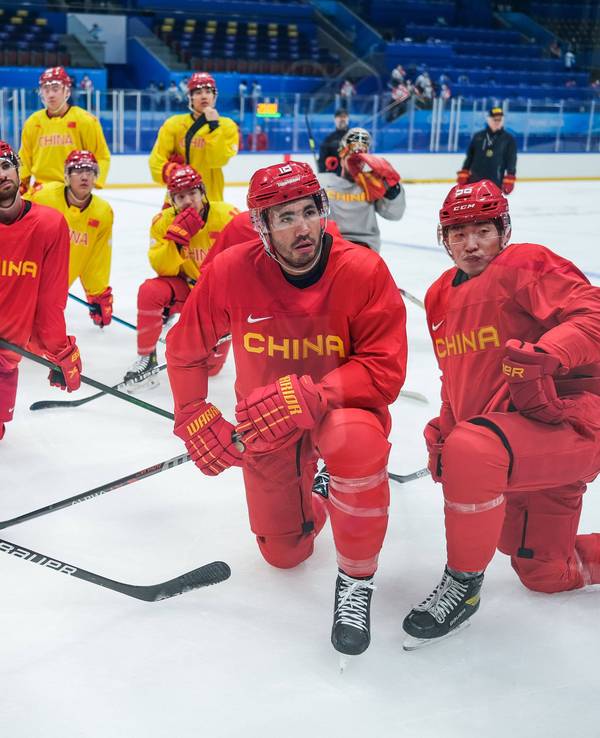 Die Spieler der Nationalmannschaft Chinas knien auf dem Eis.