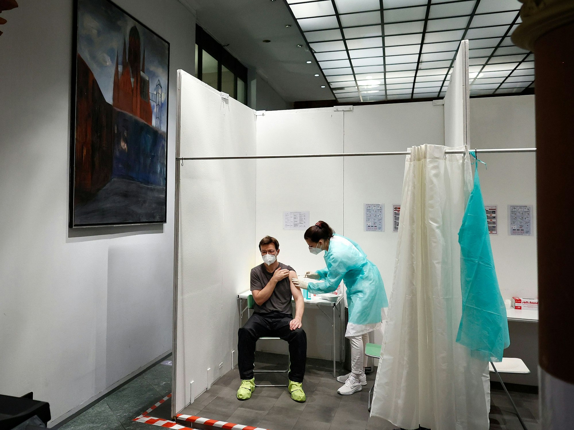 Eine Ärztin impft den Patienten Andre Wermter mit der Boosterimpfung mit dem Impfstoff Biontech in der Heilig-Kreuz-Kirche in Kreuzberg.