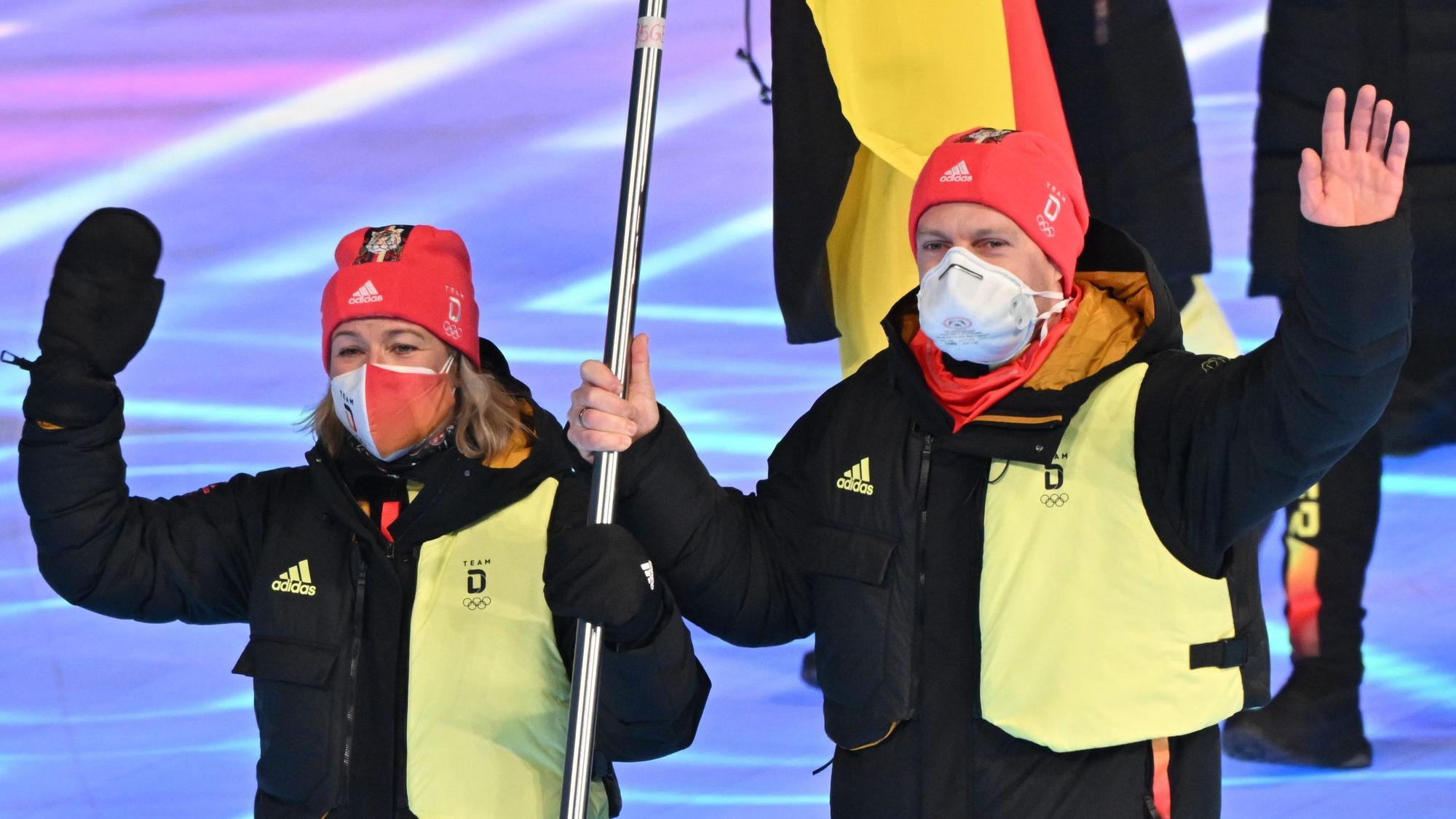 Claudia Pechstein und Francesco Friedrich tragen die deutsche Fahne ins Stadion