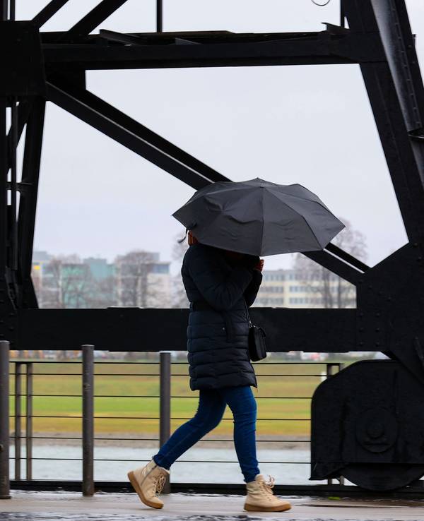 Köln:
Im Rheinauhafen versucht eine Fußgängerin Ihren Schirm fest zu halten.
Anhaltendes stürmisches Regenwetter über Köln.