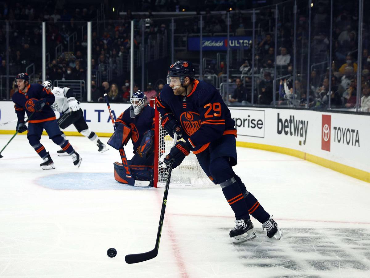 Leon Draisaitl spielt einen Puck.