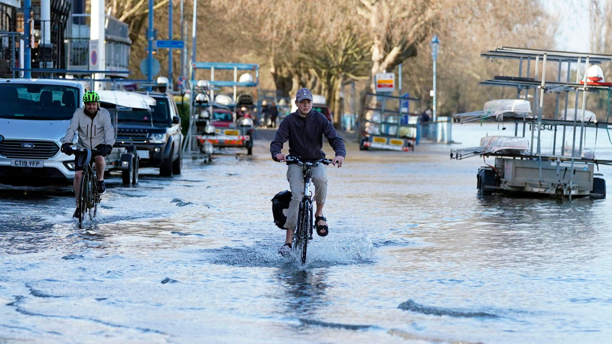 A cyclist travels through floodwater near the river Thames at Putney, London, Thursday Feb. 17, 2022, after Storm Dudley hit on Thursday night. Meteorologists warned Thursday that northern Europe could be battered by a series of storms over the coming days after strong winds swept across the region overnight. (Stefan Rousseau/PA via AP)
