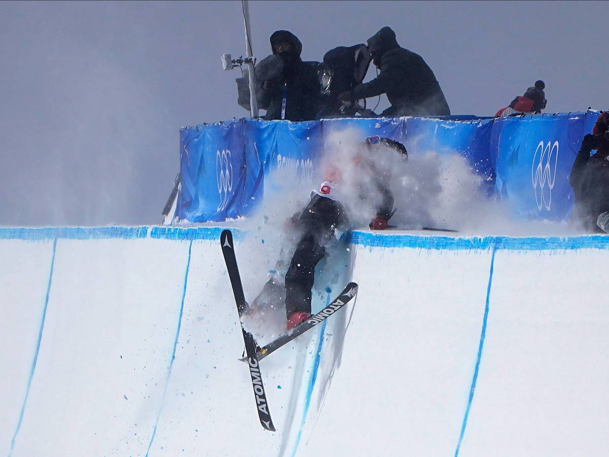 Britain's Gus Kenworthy crashes during the men's halfpipe finals at the 2022 Winter Olympics, Saturday, Feb. 19, 2022, in Zhangjiakou, China. (AP Photo/Gregory Bull)