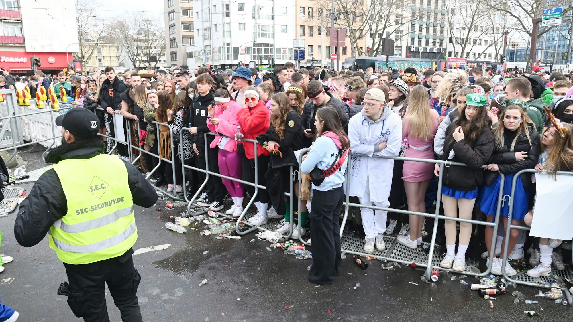 Menschen stehen am Absperrgitter an der Zülpicher Straße.