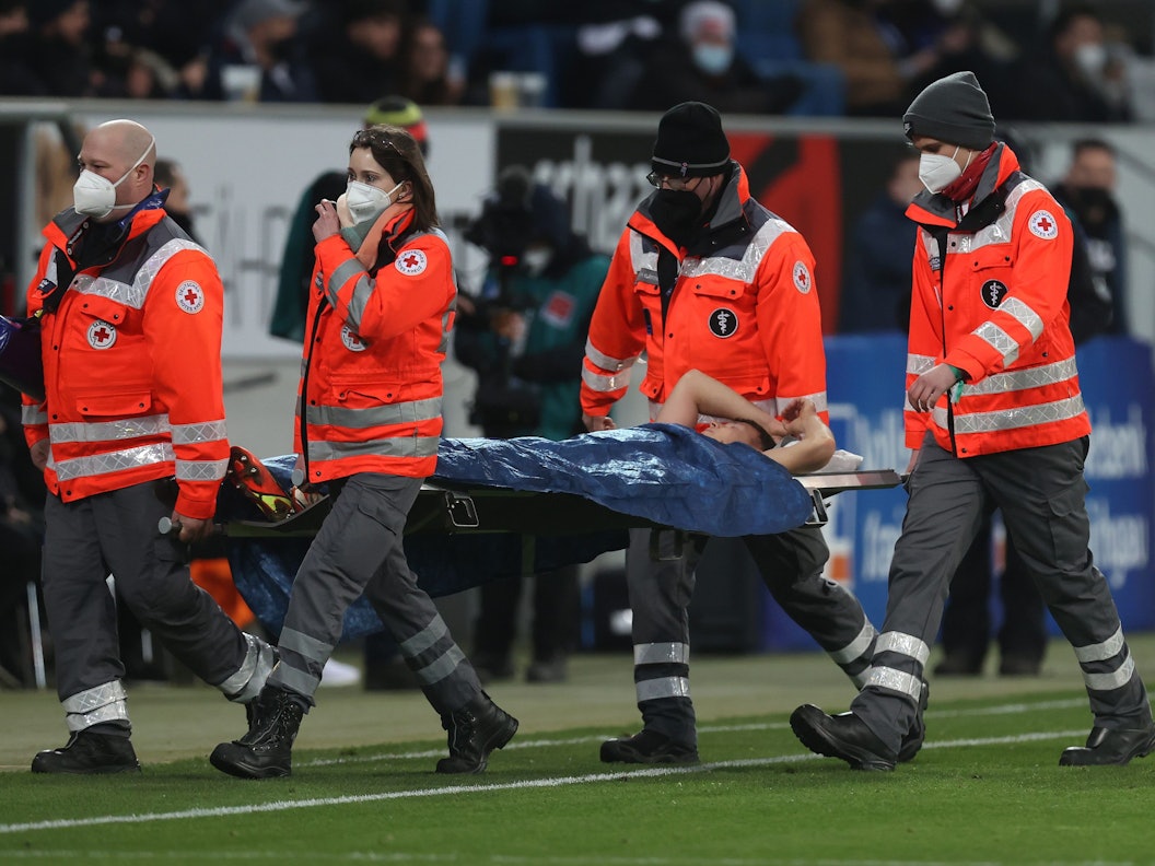 Hoffenheims Geiger muss von vier Sanitätern mit einer Trage vom Platz transportiert werden.