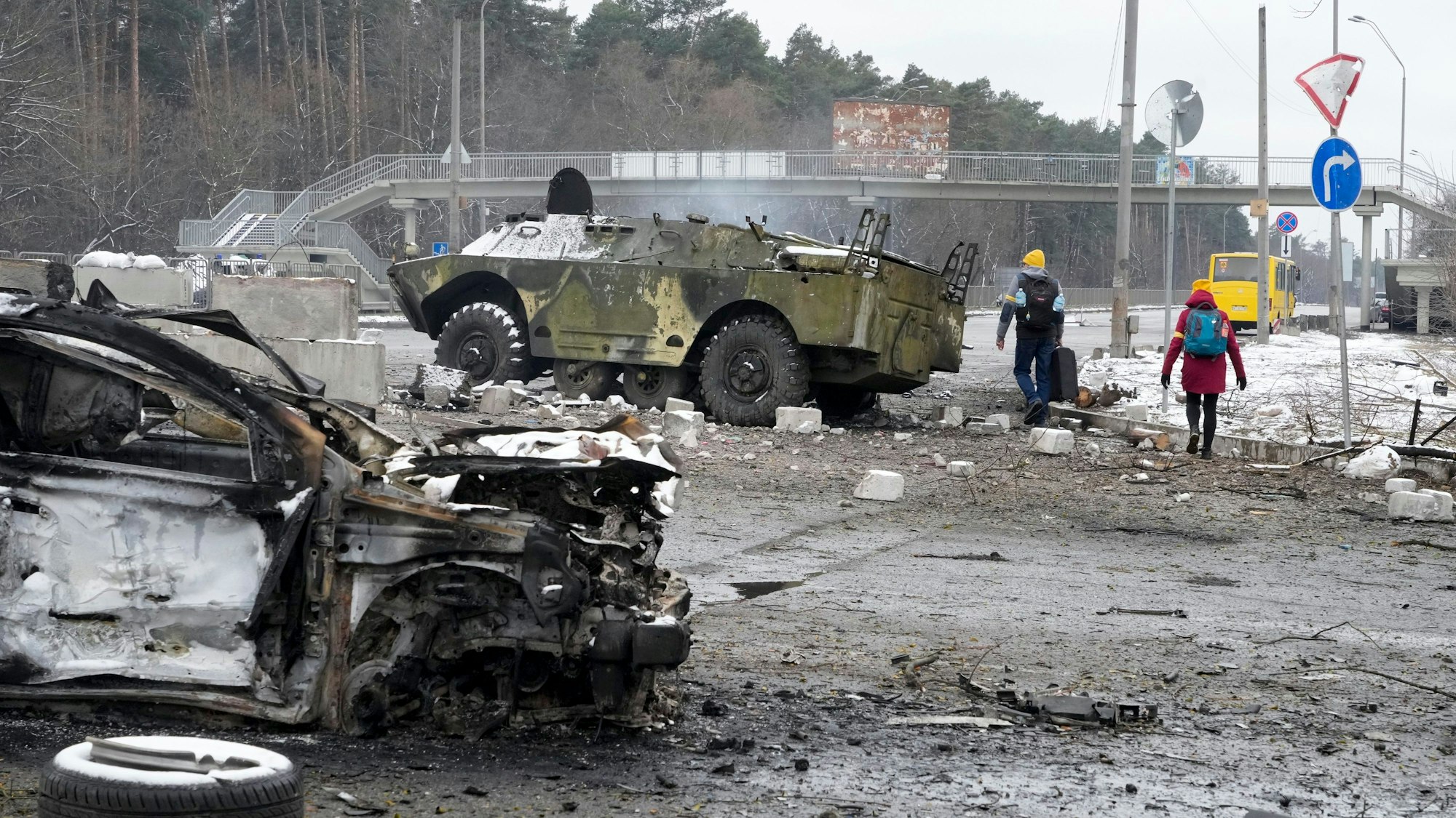 Warum greift Russland die Ukraine an? Menschen laufen am 1. März vor Kiew an völlig zerstörten Militärfahrzeugen vorbei. Seit fast einer Woche herrscht Krieg in der Ukraine. Warum eigentlich?