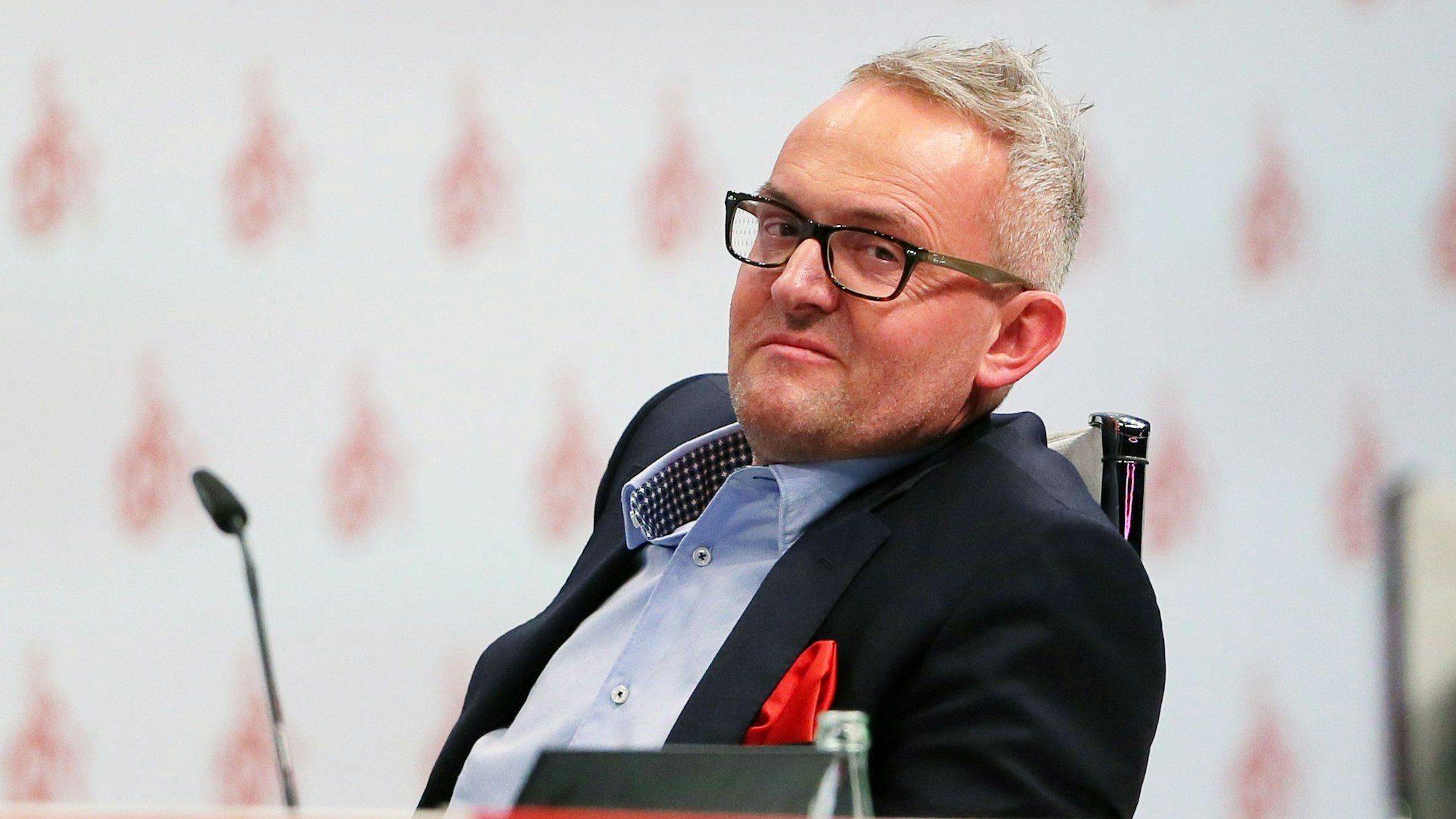 Alexander Wehrle sitzt bei der Mitgliederversammlung des 1. FC Köln in der Lanxess-Arena.