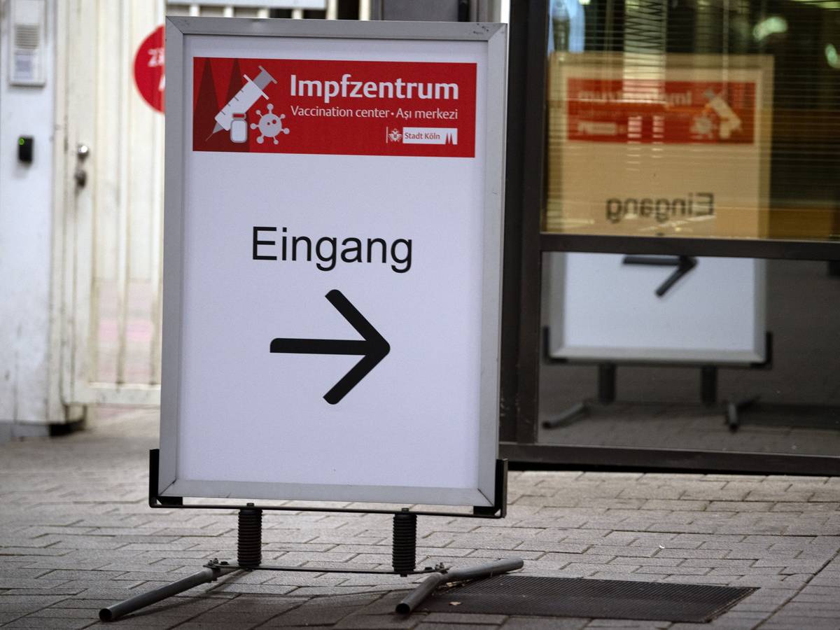 Schild weist Eingang zu einem Impfzentrum in Köln.