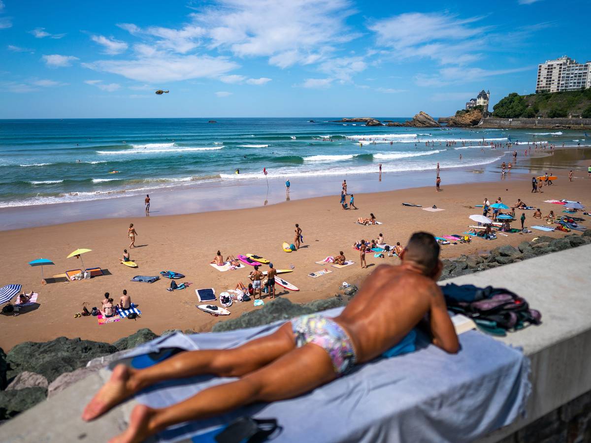 Urlauber entspannen am Strand von Biarritz in Frankreich.