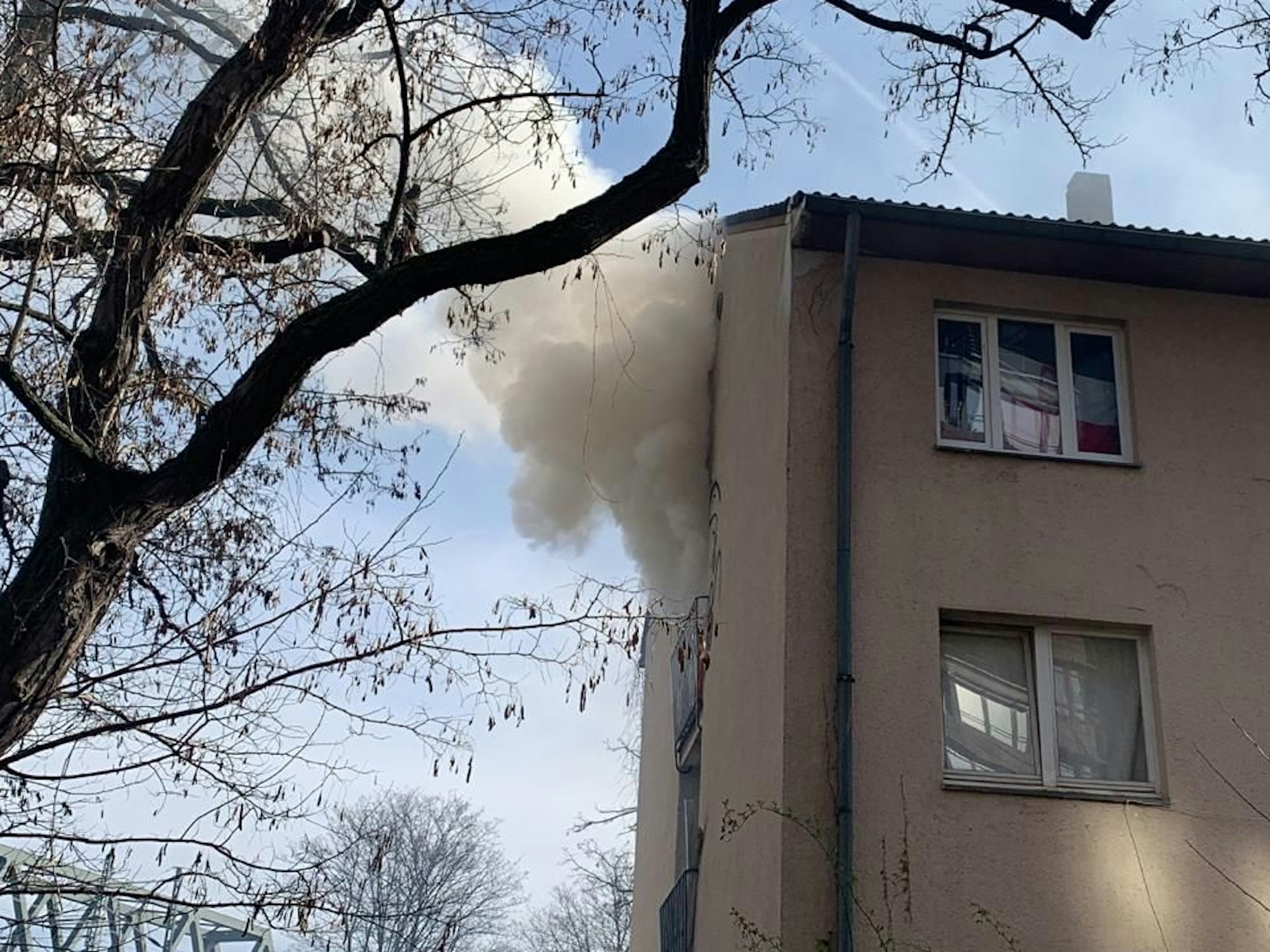 Nach einem Feuer in einem Gebäude dringt Rauch aus einem Fenster.