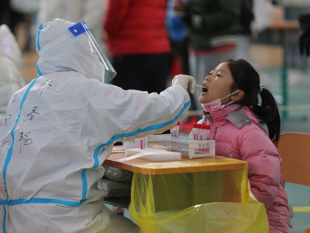 19.03.2022, China, Shenyang: Einem Mädchen in Shenyang in der nordostchinesischen Provinz Liaoning wird eine Abstrichprobe für einen Nukleinsäuretest entnommen.