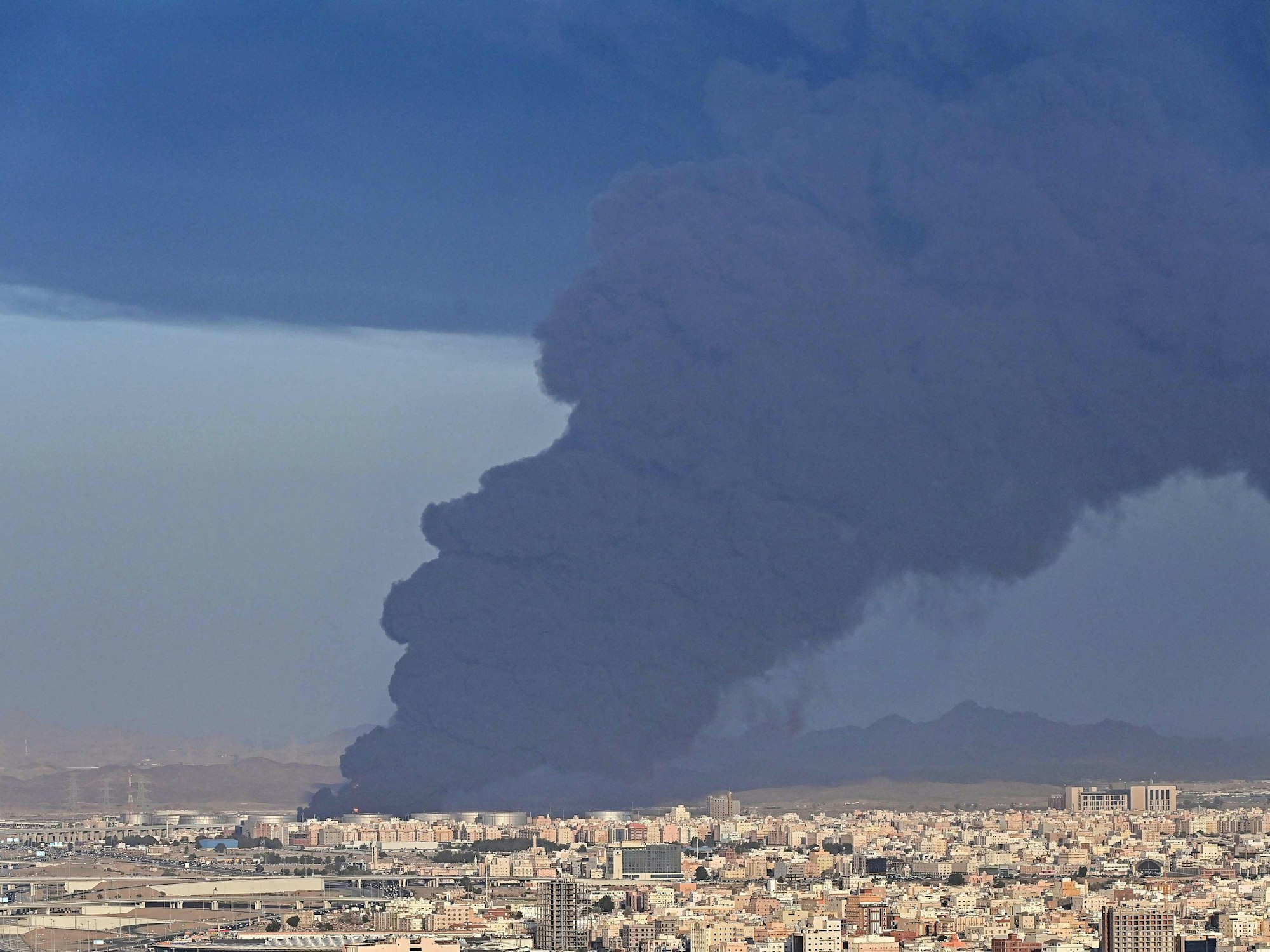 Smoke billows from an oil storage facility in Saudi Arabia's Red Sea coastal city of Jeddah on March 25, 2022. (Photo by ANDREJ ISAKOVIC / AFP)