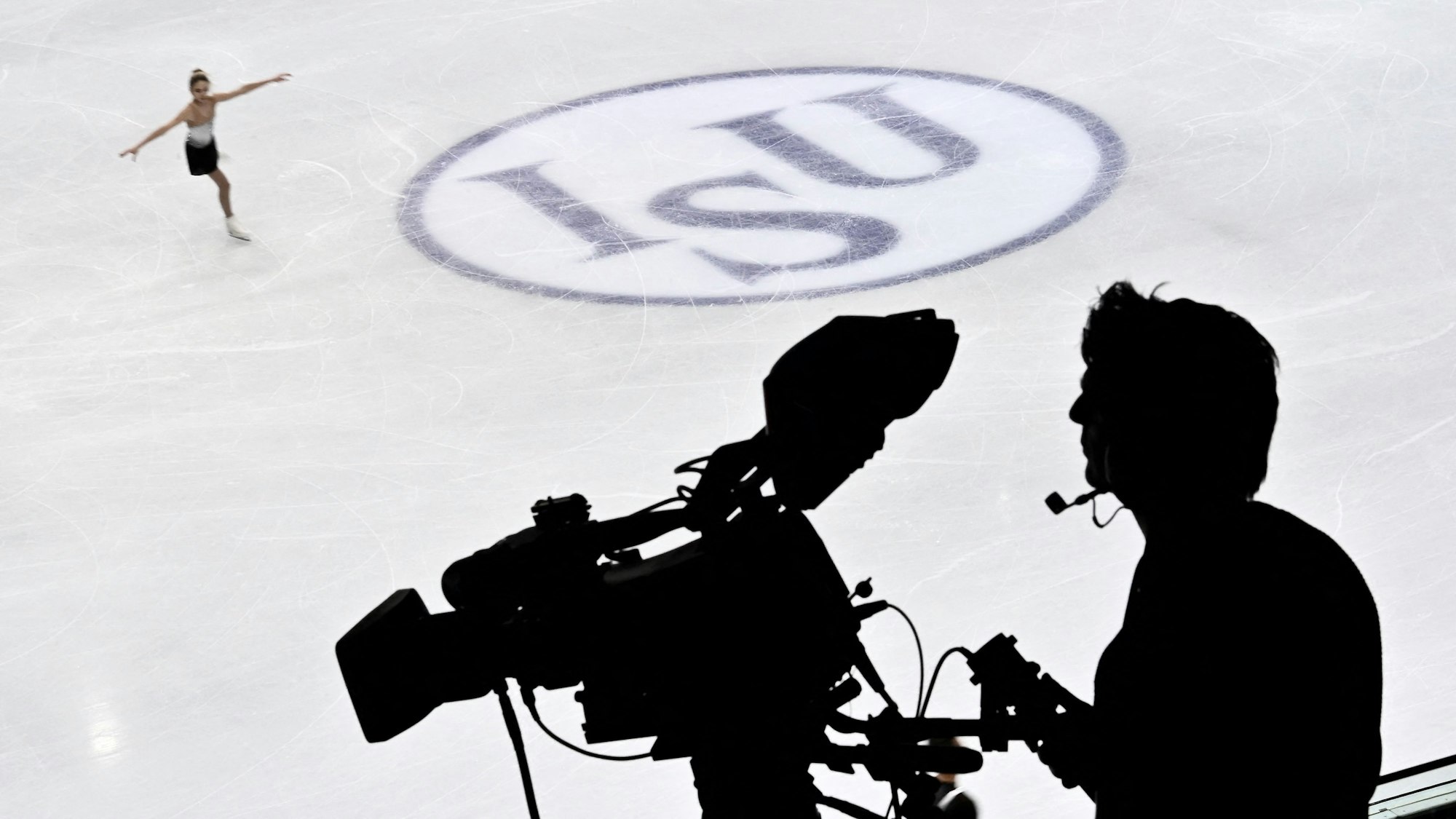 Die Silhouette eine Kameramanns bei einer Eiskunstlauf-Übertragung
