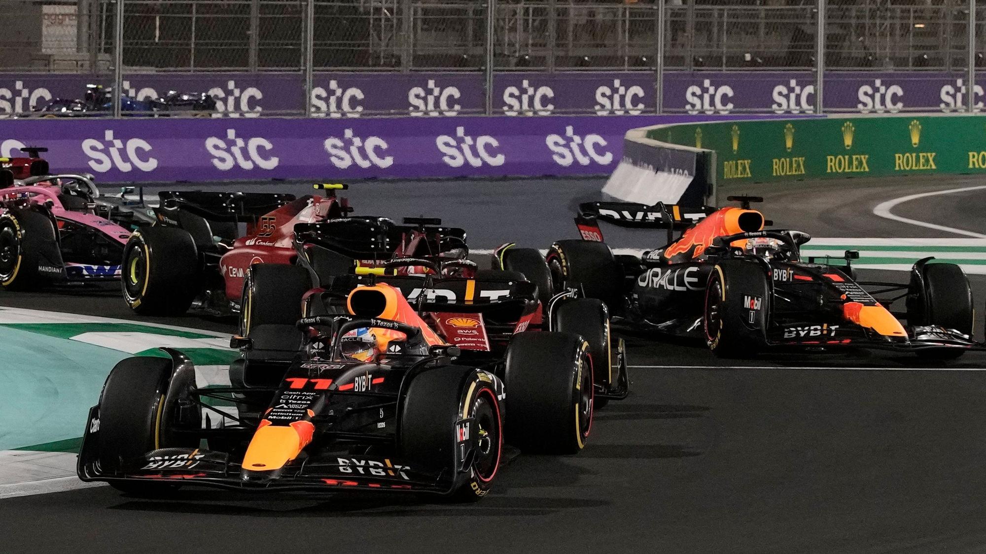 Red Bull driver Sergio Perez of Mexico leads at the start of the Formula One Grand Prix it in Jiddah, Saudi Arabia, Sunday, March 27, 2022. (AP Photo/Hassan Ammar)