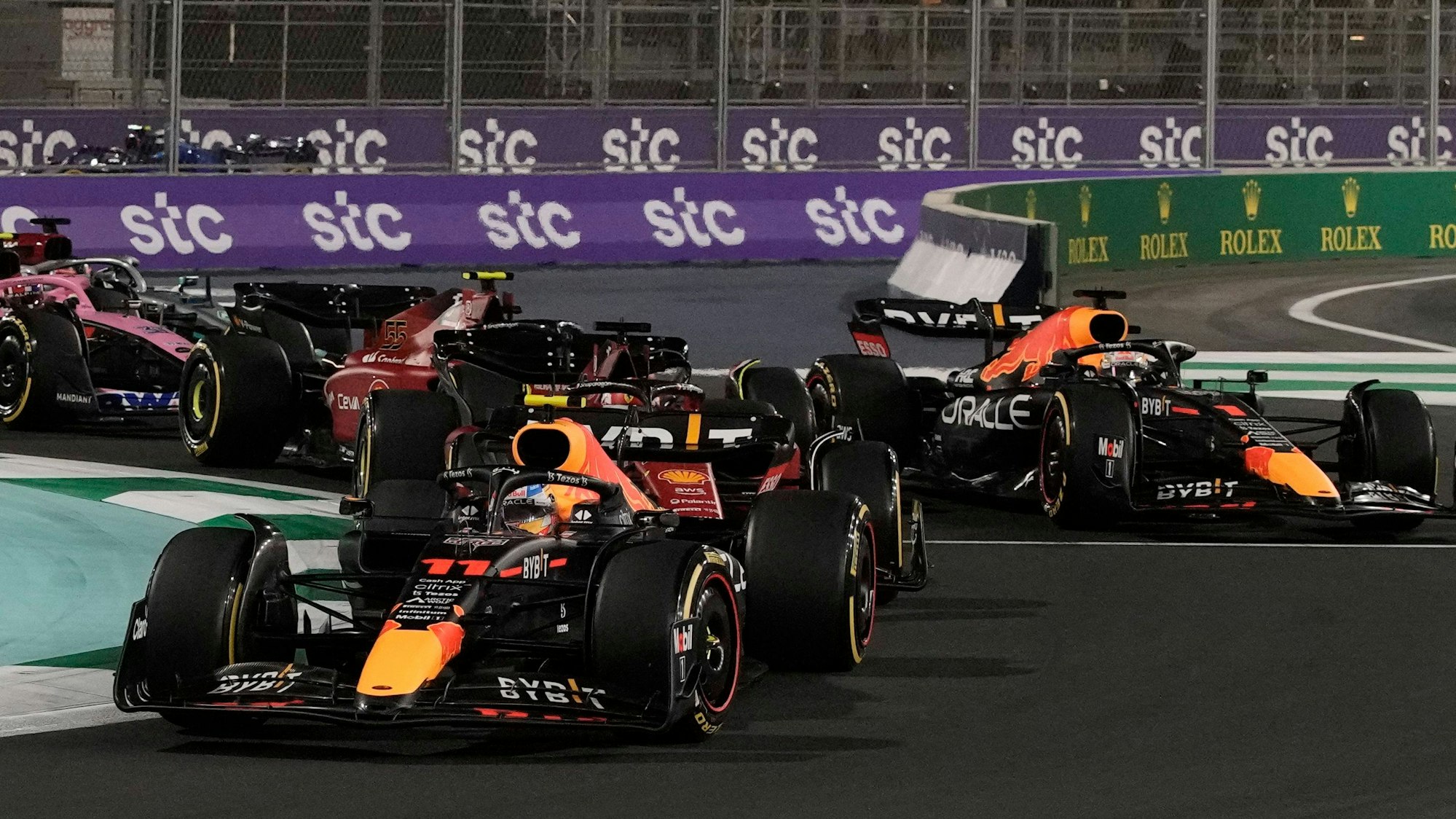 Red Bull driver Sergio Perez of Mexico leads at the start of the Formula One Grand Prix it in Jiddah, Saudi Arabia, Sunday, March 27, 2022. (AP Photo/Hassan Ammar)