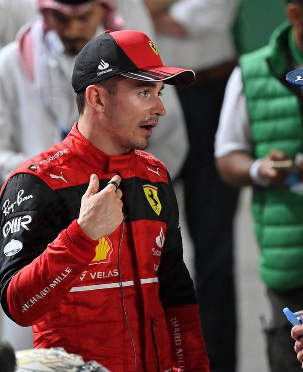 Ferrari's Monegasque driver Charles Leclerc (L) chats with Red Bull's Dutch driver Max Verstappen (R) after the 2022 Saudi Arabia Formula One Grand Prix at the Jeddah Corniche Circuit on March 27, 2022. (Photo by ANDREJ ISAKOVIC / AFP)