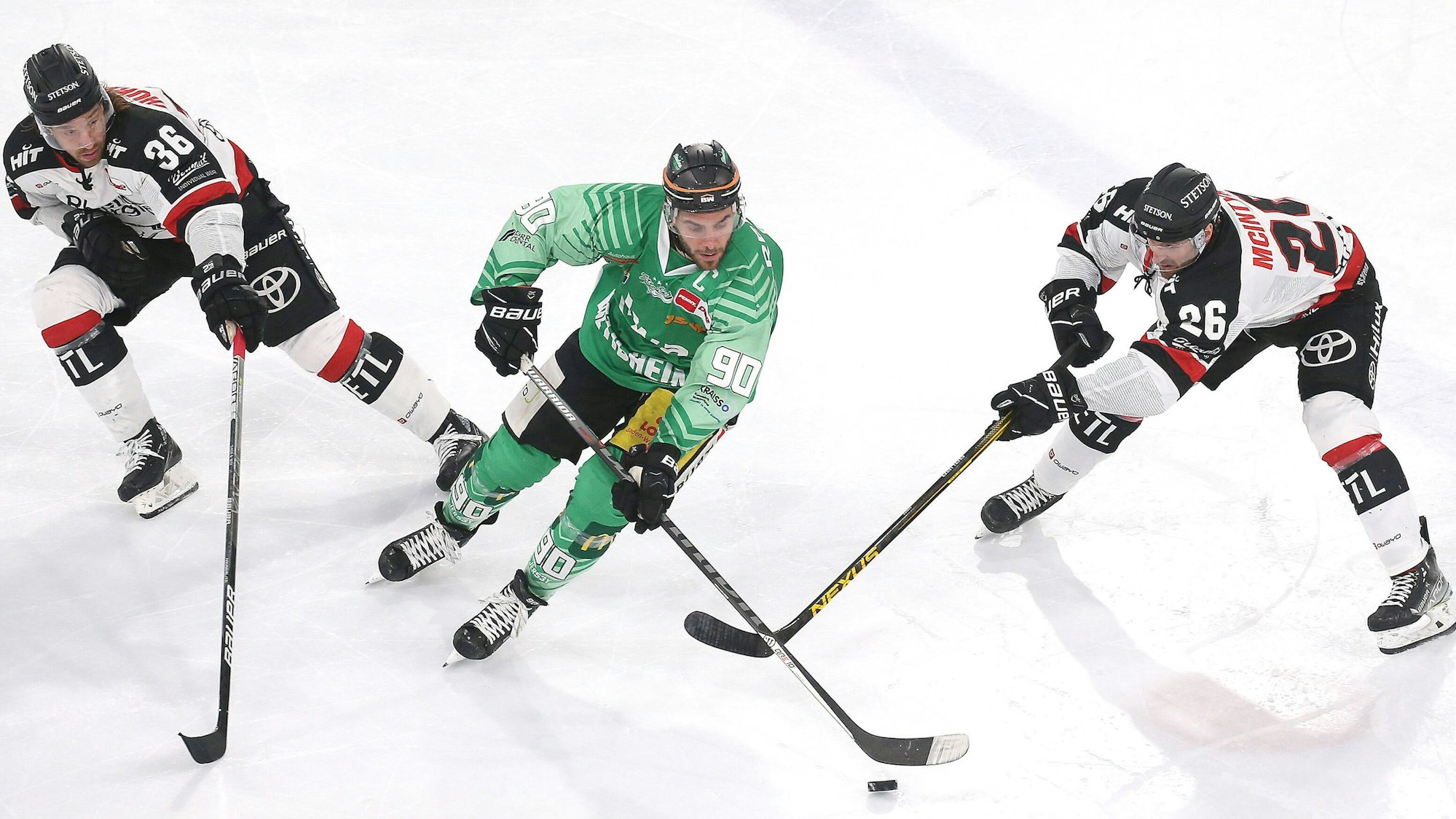 Andreas Thuresson, Constantin Braun und David McIntyre kämpfen um den Puck