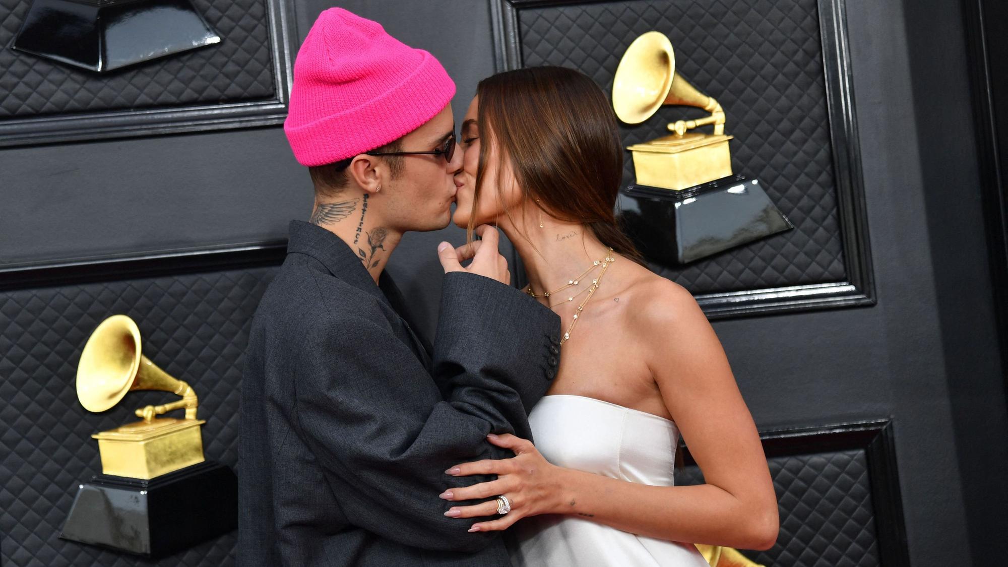 Canadian singer-songwriter Justin Bieber (L) and US model Hailey Bieber arrive for the 64th Annual Grammy Awards at the MGM Grand Garden Arena in Las Vegas on April 3, 2022.