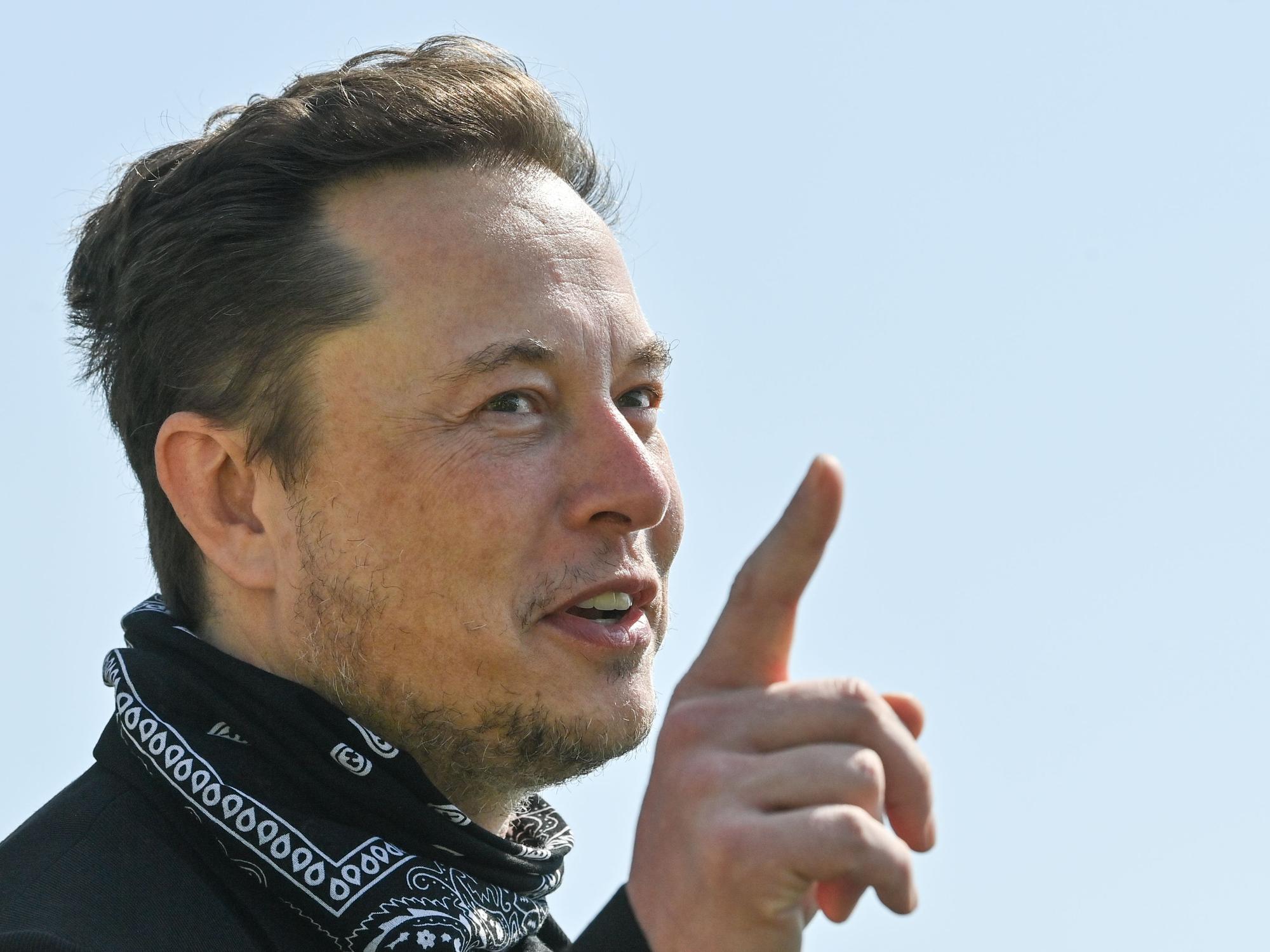 Elon Musk, Tesla-Chef, steht bei einem Pressetermin auf dem Gelände der Tesla Gigafactory und hebt den Finger.