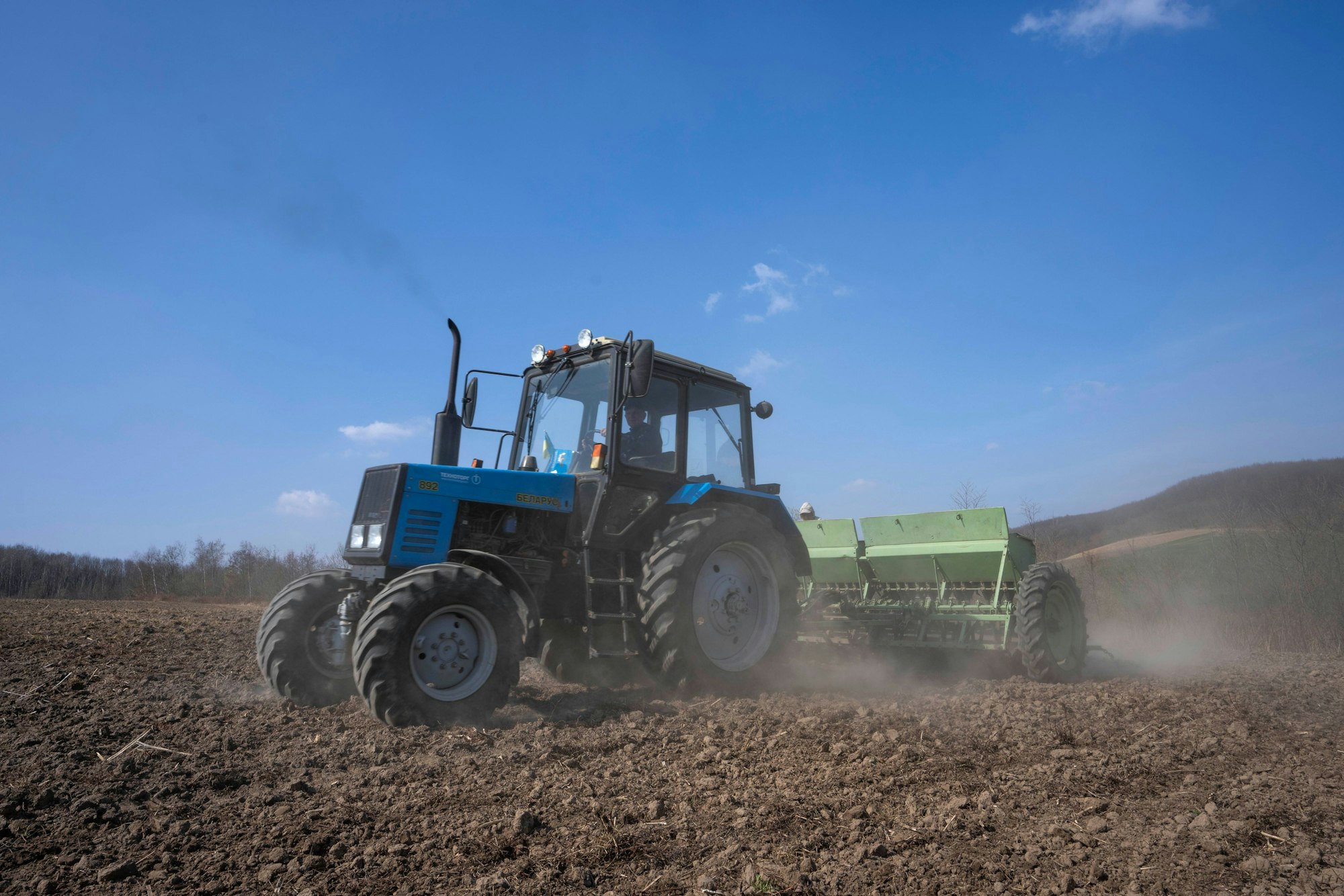 Arbeiter pflügen ein Weizenfeld im Westen der Ukraine. In der Ukraine hat die Aussaat- und Pflanzsaison begonnen.