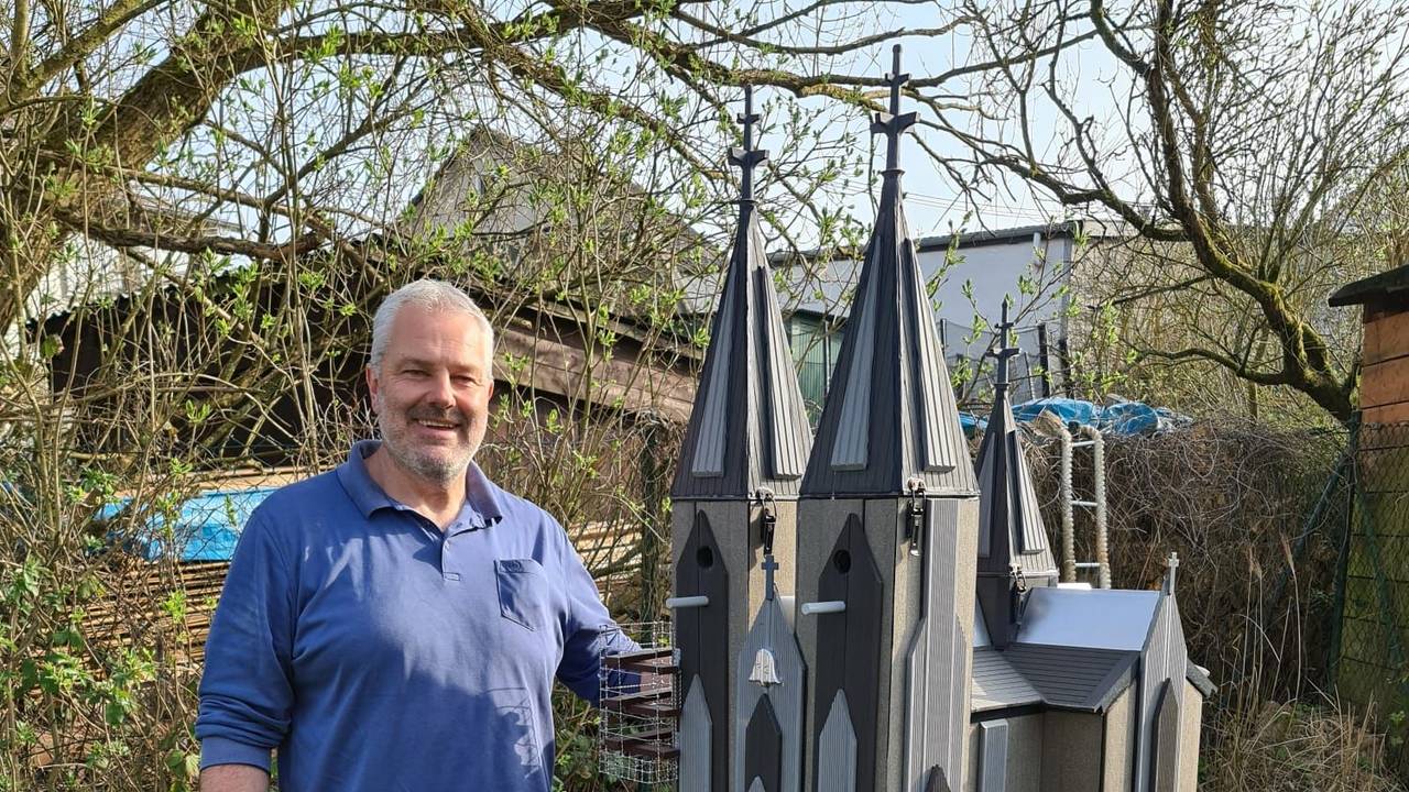 Frank Hirschfeld steht neben seinem Vogelhaus im Garten.