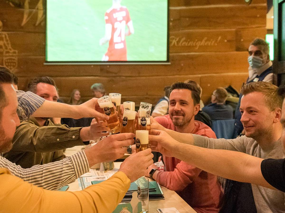 Eine Gruppe von Männern stößt mit Bier an.