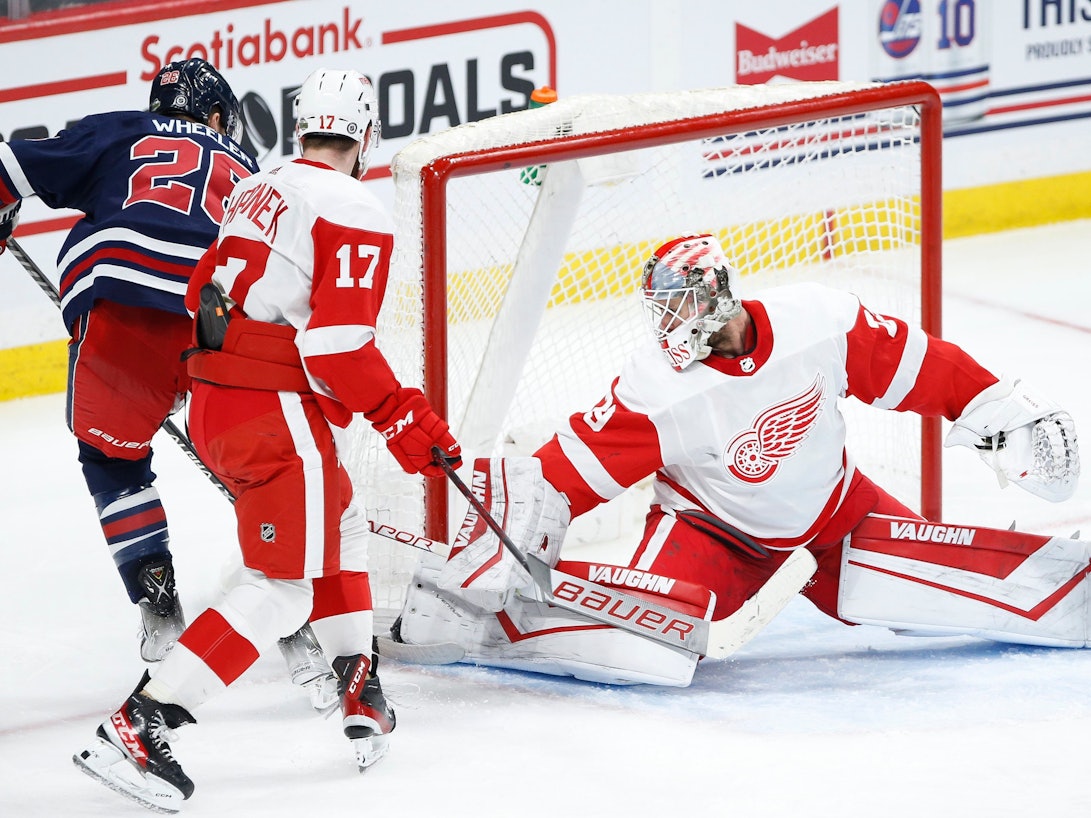 Thomas Greiss hält den Puck, den Jets-Spieler Blake Wheeler aufs Tor bringt.